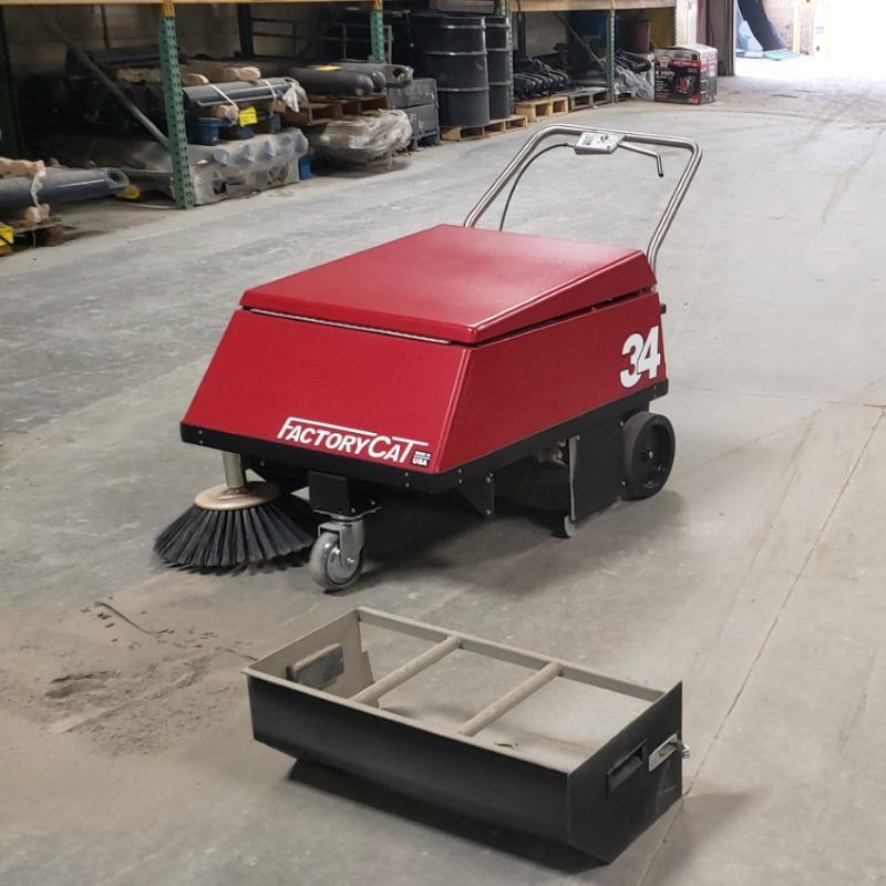 FactoryCat Walk Behind Floor Sweepers 34 production areas concrete - https://assets.factorycat.com/demoImages/2025/april/34-Walk Behind Floor Sweepers-production areas-concrete-St. Louis-USA-404.jpg - 800 - 800 - 404 A FactoryCat 34 battery floor sweeper cleaning the concrete maintenance shop floor of a foundry in St. Louis, MO