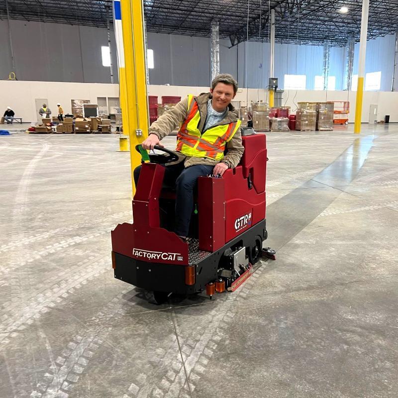 FactoryCat Ride On Floor Scrubbers GTR warehouse concrete - https://assets.factorycat.com/demoImages/2025/april/GTR-Ride On Floor Scrubbers-warehouse-concrete-St. Paul-USA-396.jpg - 800 - 800 - 396 A GTR battery ride on floor scrubber performing new construction clean up of a warehouse concrete floor in St. Paul, MN