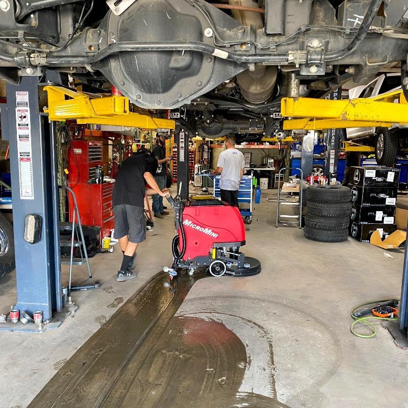 FactoryCat Walk Behind Floor Scrubbers MicroMini service bay concrete - https://assets.factorycat.com/demoImages/2025/april/MicroMini-Walk Behind Floor Scrubbers-service bay-concrete-Los Angeles-USA-309.jpg - 800 - 800 - 309 A MicroMag floor scrubber cleans a service bay of a an auto repair shop in in Los Angeles, CA.