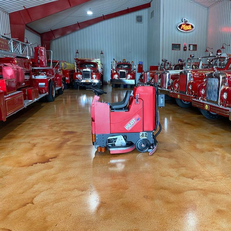 FactoryCat Ride On Floor Scrubbers Pilot garage epoxy - https://assets.factorycat.com/demoImages/2025/april/Pilot-Ride On Floor Scrubbers-garage-epoxy-Phillidephia-USA-604.jpg - 800 - 800 - 604 Pilot battery Ride On Floor Scrubbers cleaning a fire engine museum in Pennsylvania