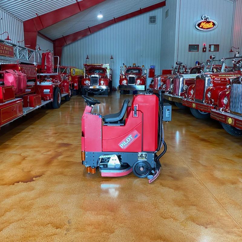 FactoryCat Ride On Floor Scrubbers Pilot garage epoxy - https://assets.factorycat.com/demoImages/2025/april/Pilot-Ride On Floor Scrubbers-garage-epoxy-Phillidephia-USA-607.jpg - 800 - 800 - 607 Pilot battery Ride On Floor Scrubbers cleaning a fire engine museum in Pennsylvania